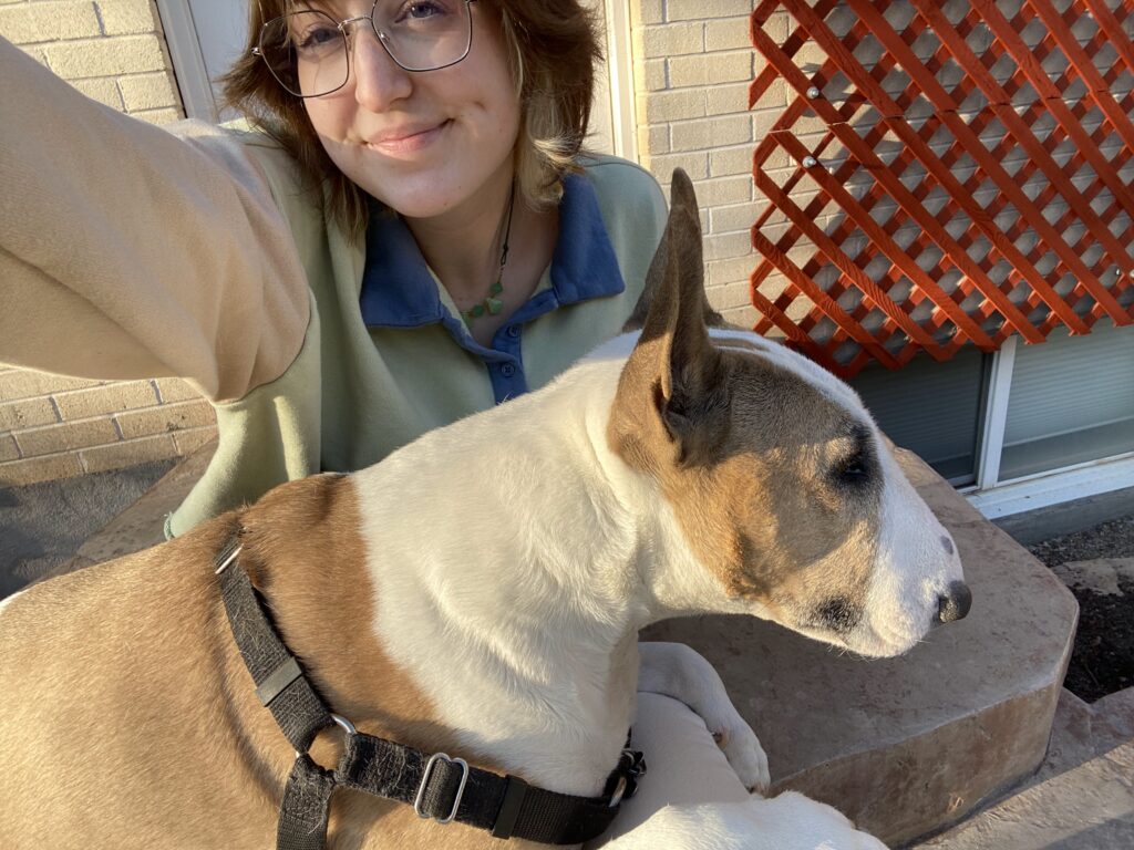 A picture of me sitting on steps with a bull terrier sitting on my lap